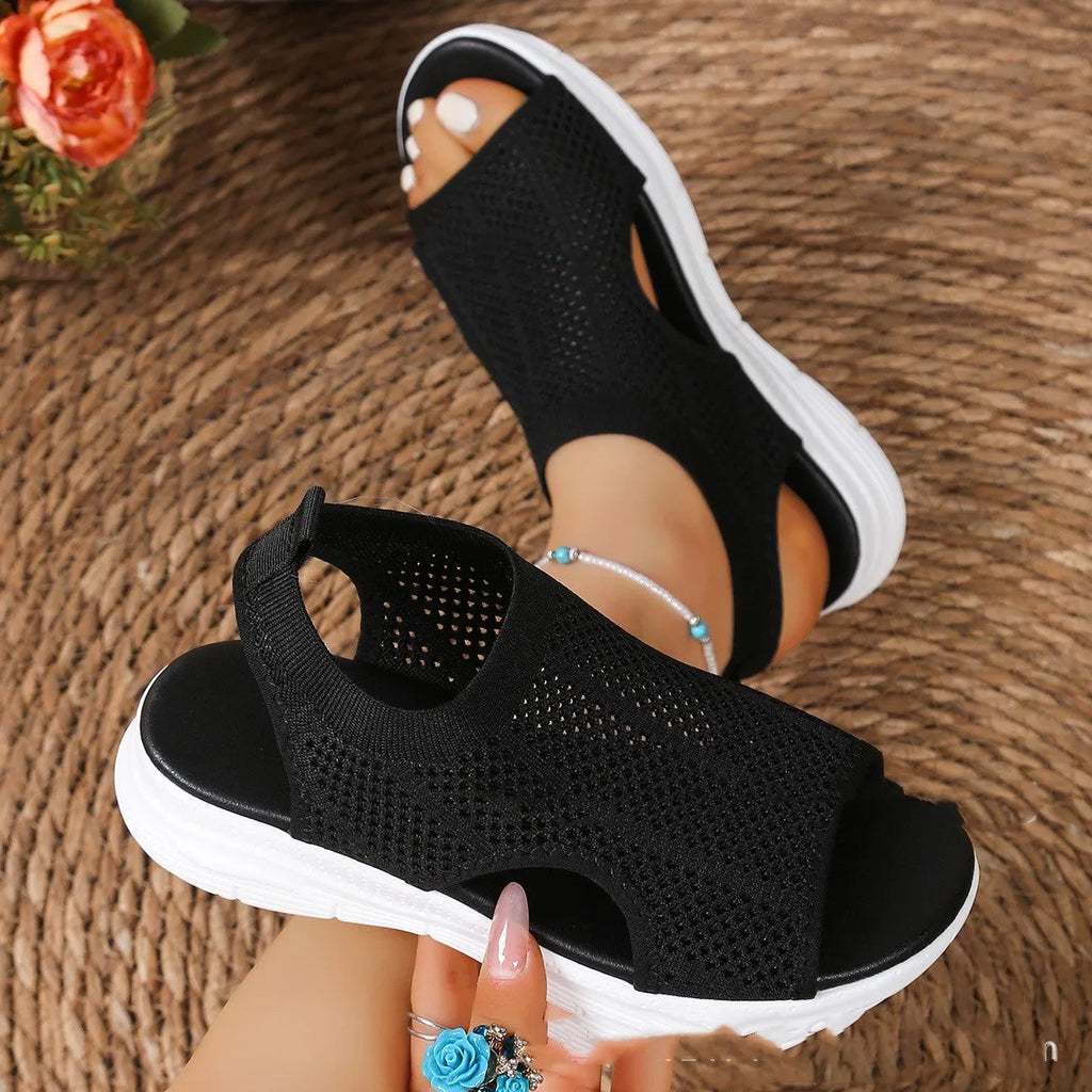 Women's flat platform sports sandals in black with mesh lining and a rubber sole.