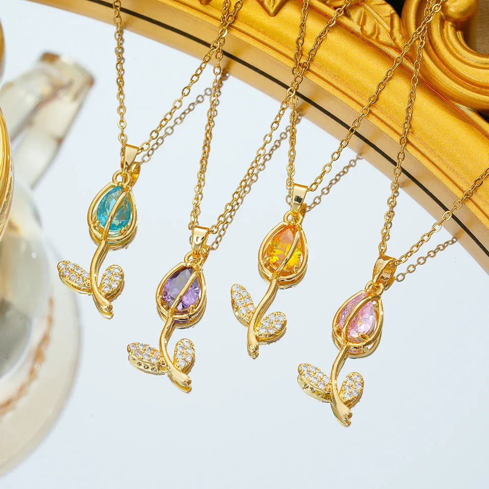 Gold coloured titanium steel necklace with a detailed zircon tulip flower pendant on an O-ring chain.