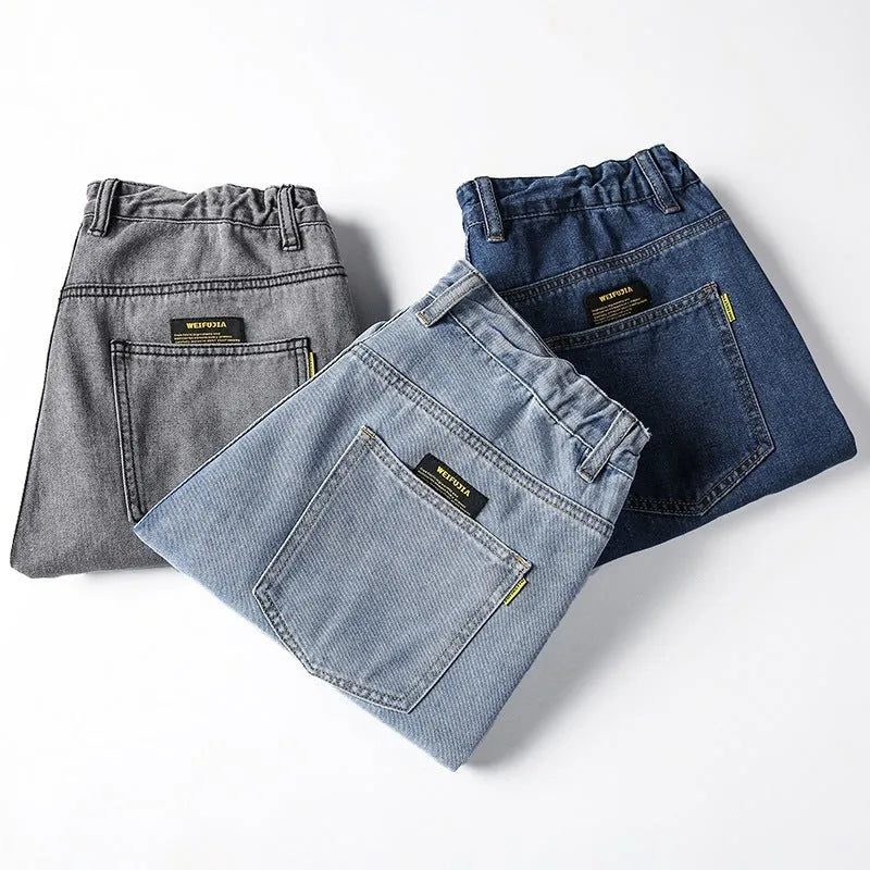 Men's loose straight leg jeans in dark blue cotton denim with a mid-rise waist and zipper fly