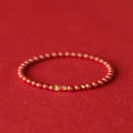 Traditional Chinese cinnabar koi bracelet with natural raw ore materials and golden ball design in 4mm or 6mm sizes