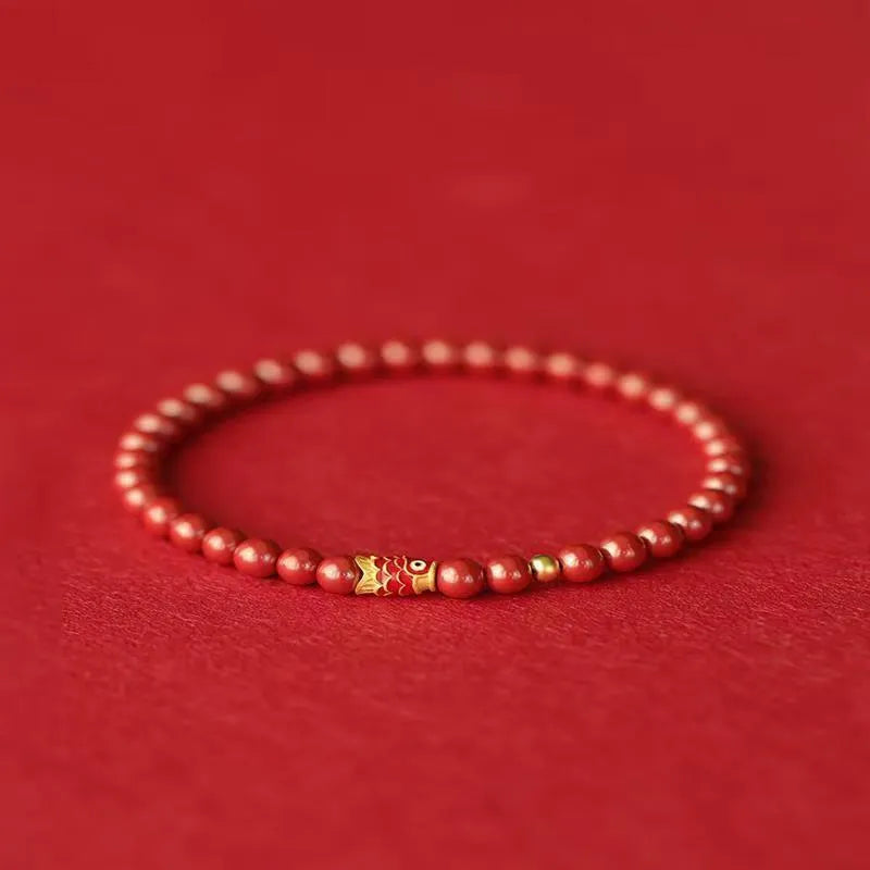 Traditional Chinese cinnabar koi bracelet with natural raw ore materials and golden ball design in 4mm or 6mm sizes
