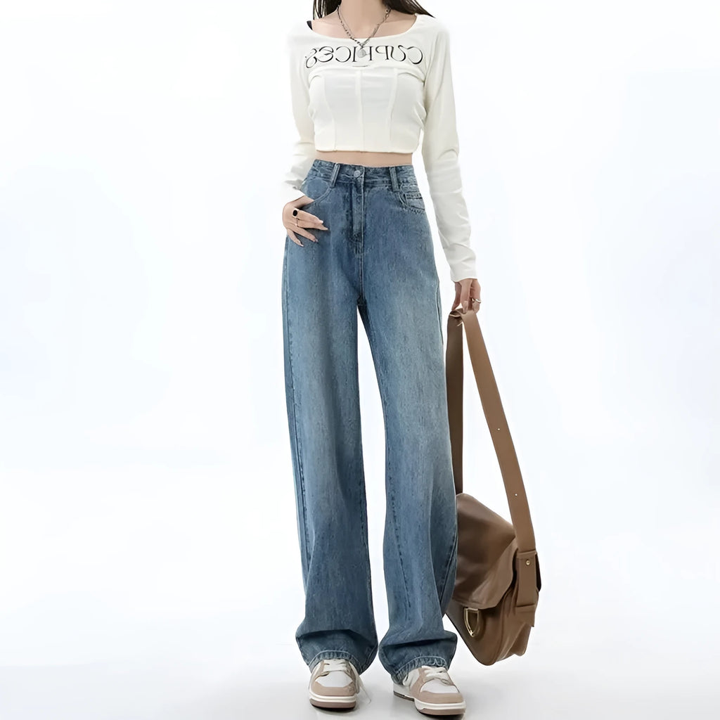 Woman wearing retro blue high waist wide leg jeans with a straight leg cut.