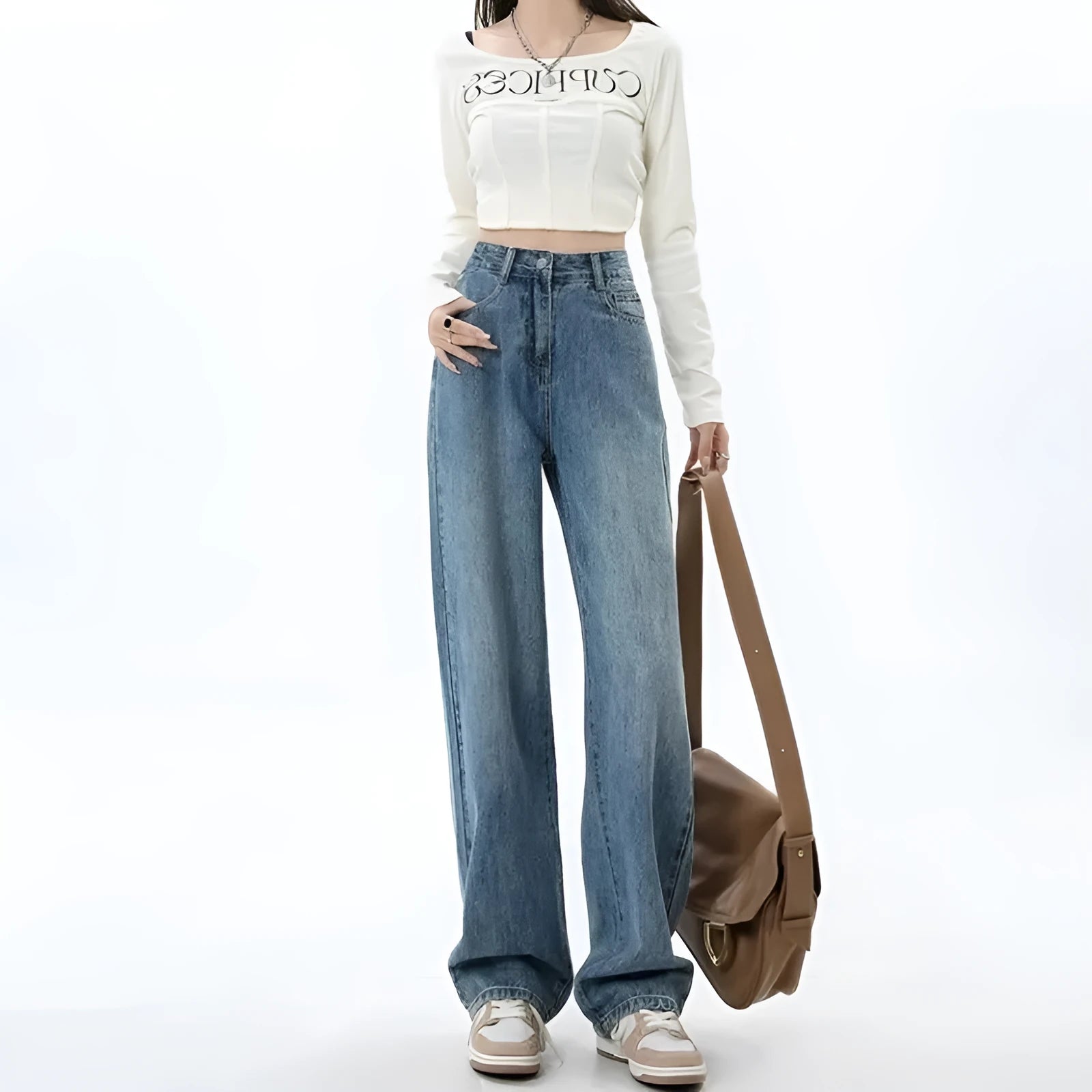 Woman wearing retro blue high waist wide leg jeans with a straight leg cut.