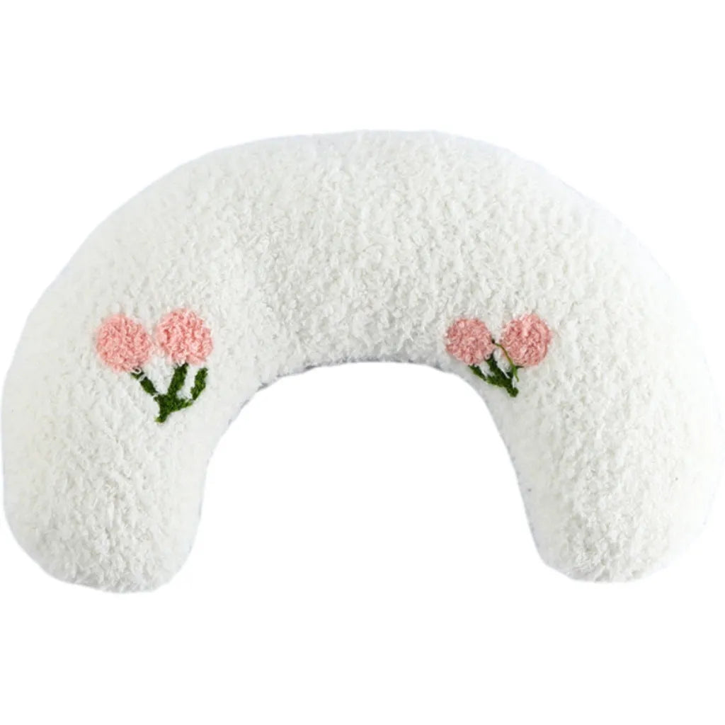 Small blue half-donut shaped pet pillow bed for cats or small dogs on a carpet.