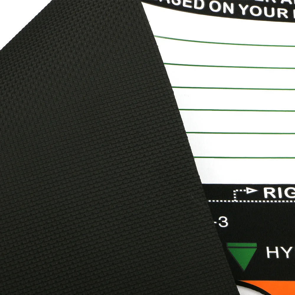 Black rectangular neoprene golf swing stance posture training pad on a green surface.
