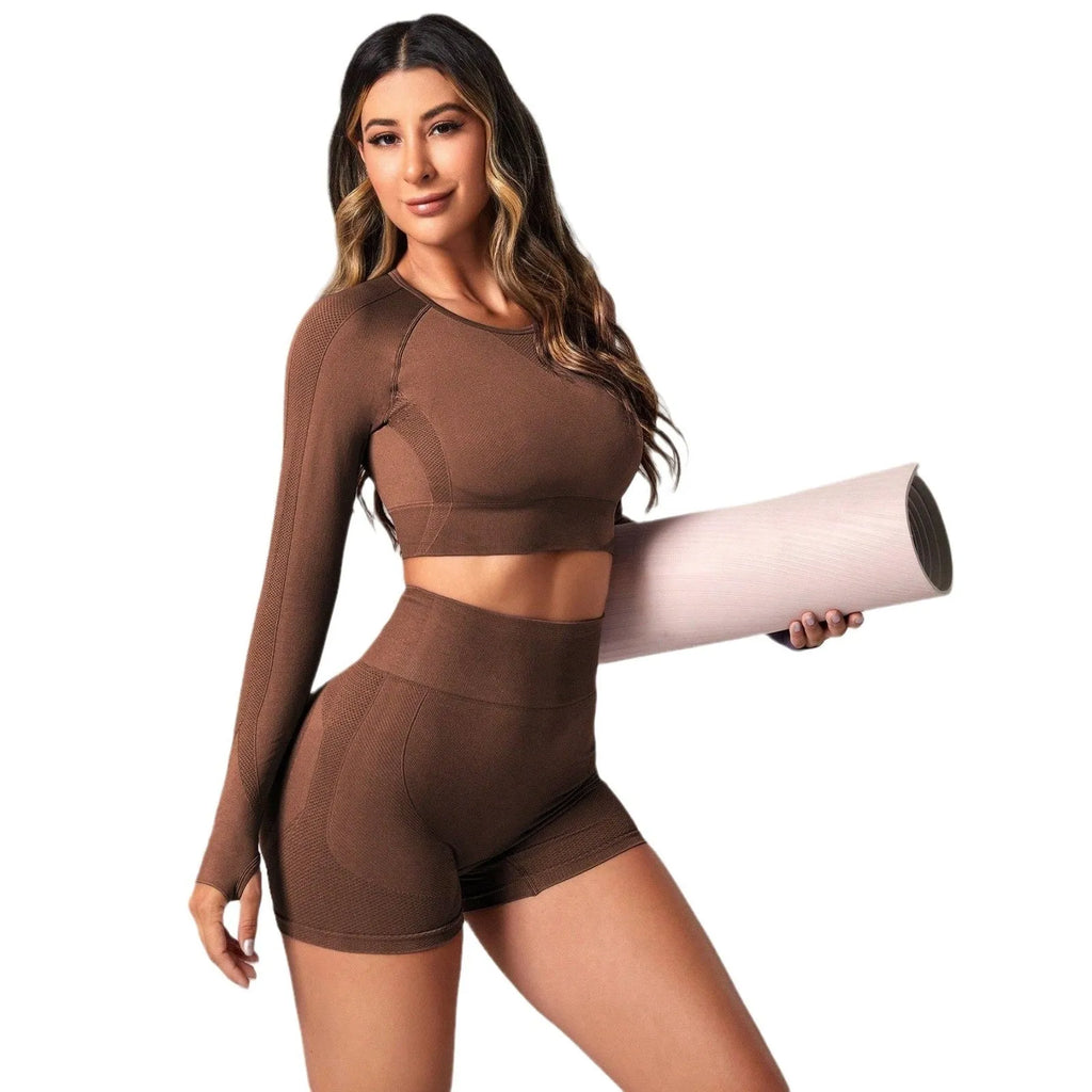 Women's black high-waist yoga suit with long sleeve top and tight-fit pants laid flat.