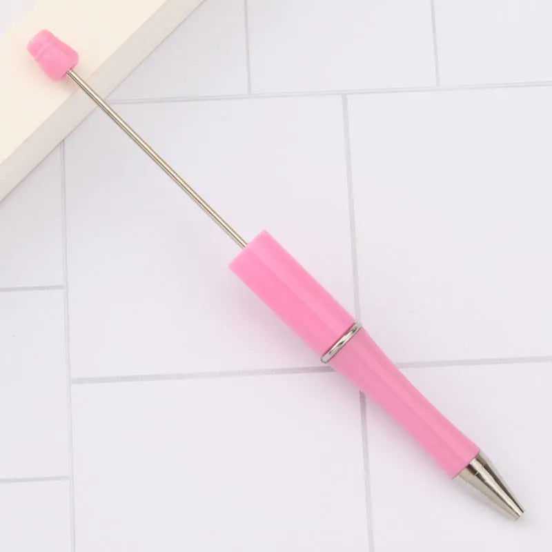 Ballpoint pen with colourful spinning plastic beads on barrel, shown in a gradient purple finish.