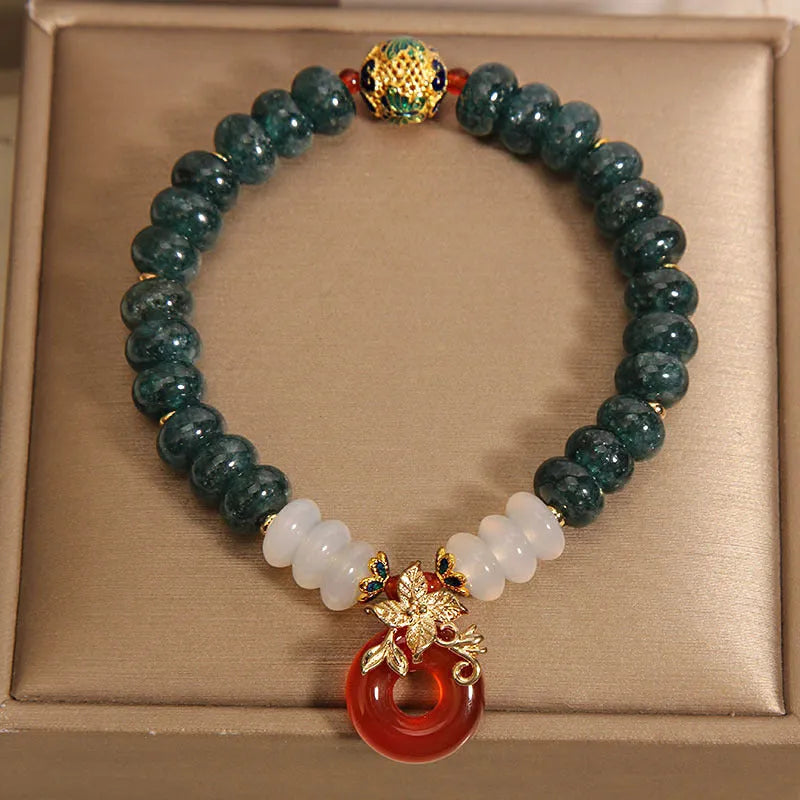 Blue water jade and red agate stone bracelet with peace buckle closure on crystal band
