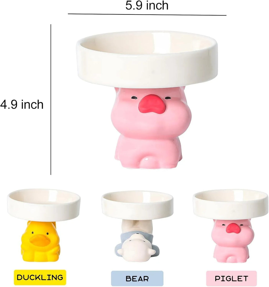 Raised ceramic cat bowl with cute animal design in pink, yellow, or white on a white background