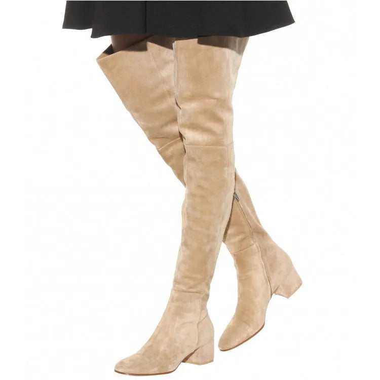 Grey women's suede over-the-knee flat boots with pointed toe and low thick heel on a rubber sole.