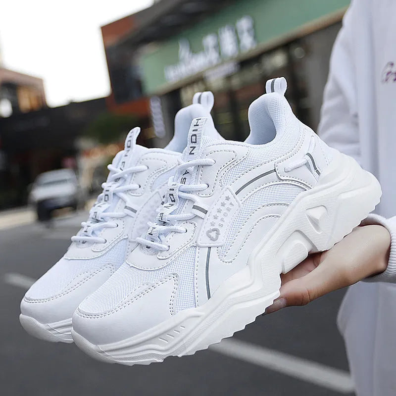 White women's casual sports shoe with mesh upper, thick PU sole, and buckle strap.