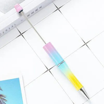 Ballpoint pen with colourful spinning plastic beads on barrel, shown in a gradient purple finish.