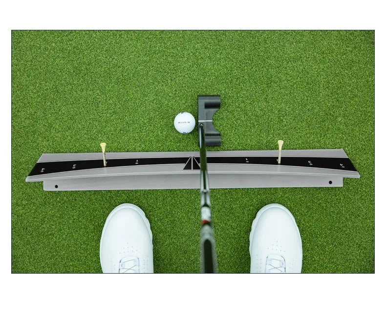 Golf putter trajectory balance simulator with adjustable push rod on a flat surface.