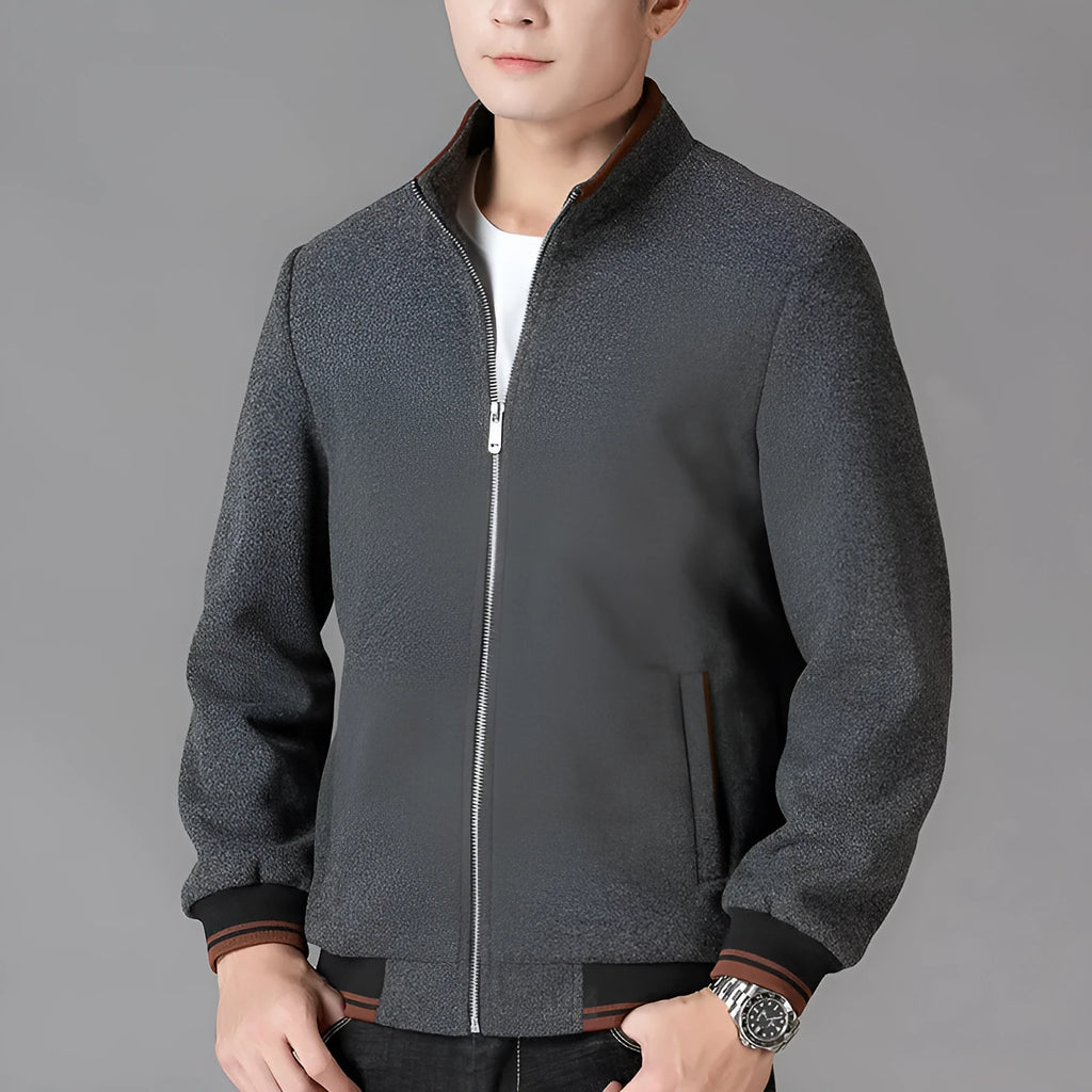 Men's grey polyester fleece sports jacket with long sleeves and a stick pocket.