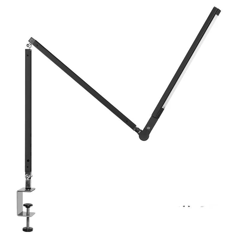 Black folding clip-on LED desk lamp with remote control on a wooden desk.