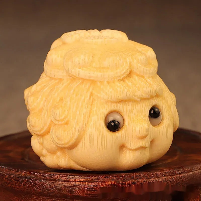Golden Toad Princess ornament carved from solid bamboo on a wooden surface.