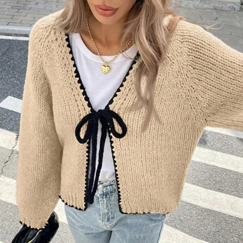 Grey loose-fit lace-up cardigan with long sleeves and a crochet flower detail on the front.