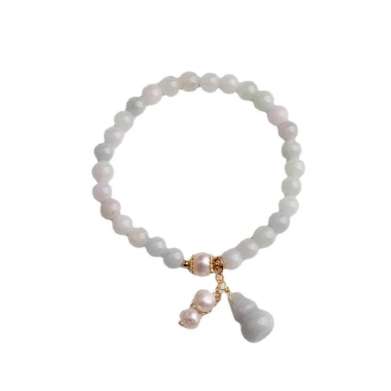 Natural jade bracelet with hand-carved gourd design in Chinese women's style.