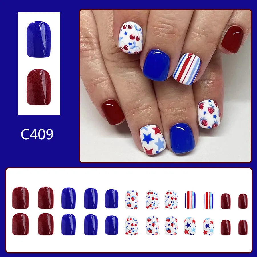 Short glossy press-on nails with strawberry and cherry图案 in red and blue colours