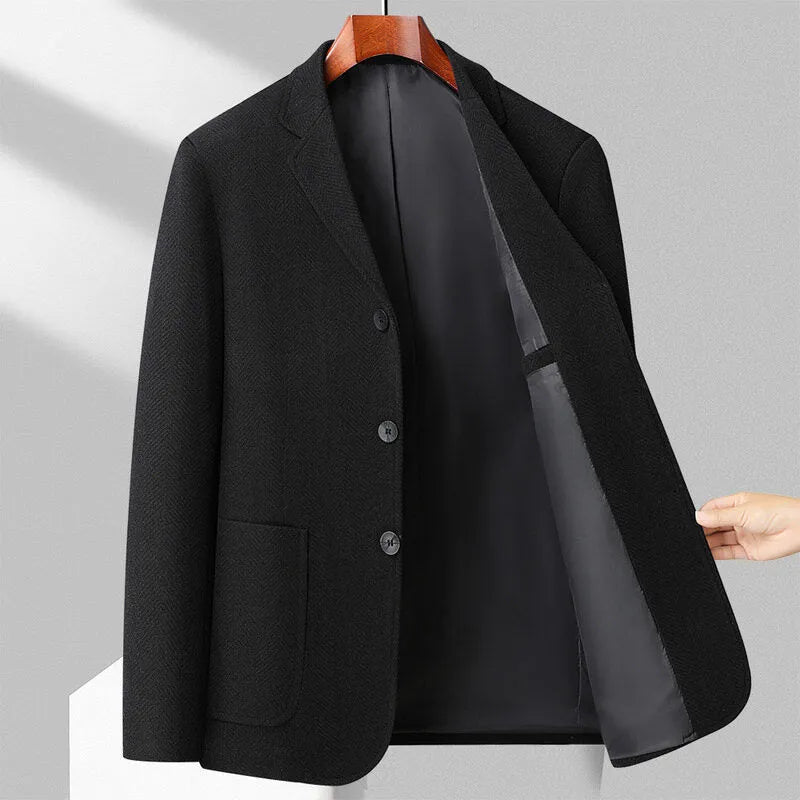 Man wearing a classic solid-colour, loose-fit wool blend coat suitable for spring and autumn.