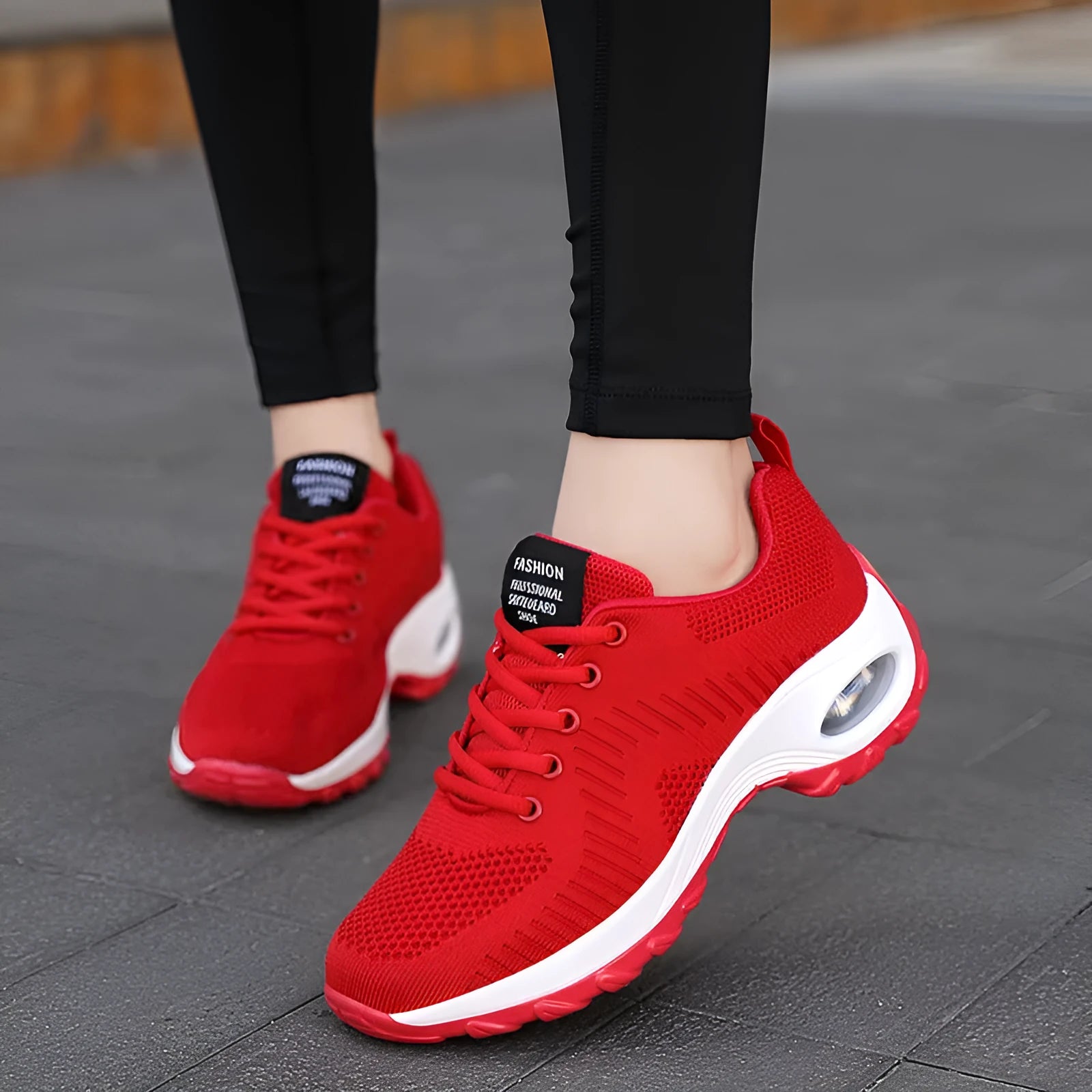 Women's black mesh sneakers with round toe, front lace-up closure, and mid heel on grey background