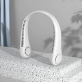 White USB rechargeable bladeless neck fan being worn, showing adjustable speed buttons.