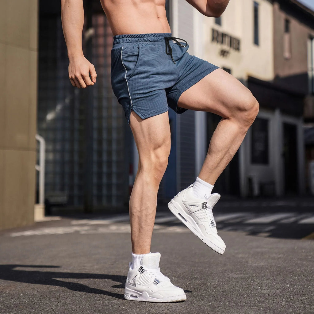 Men's black polyester straight-leg fitness sports shorts on a grey background.