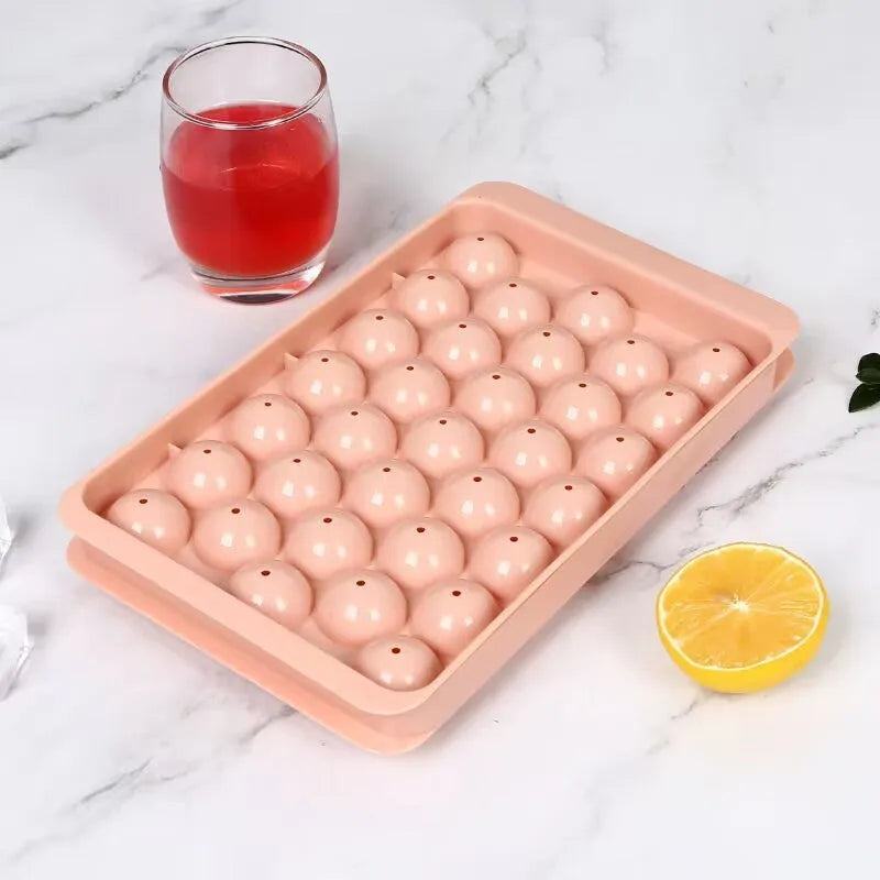 Blue silicone ice cube tray with lid showing 33 round grids for ice making