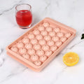 Blue silicone ice cube tray with lid showing 33 round grids for ice making