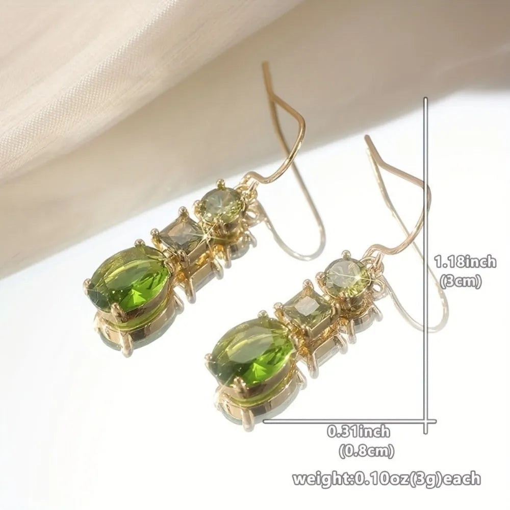 A pair of green geometric quadrilateral copper earrings in a bohemian style for unisex wear.