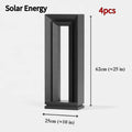 Modern square stainless steel outdoor garden lamp with geometric design on a patio.