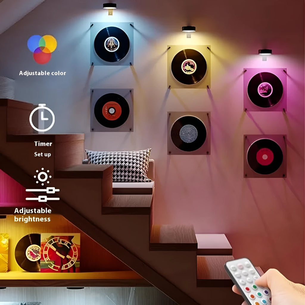 Black remote control LED magnetic picture light mounted above a painting, showing wireless power supply.