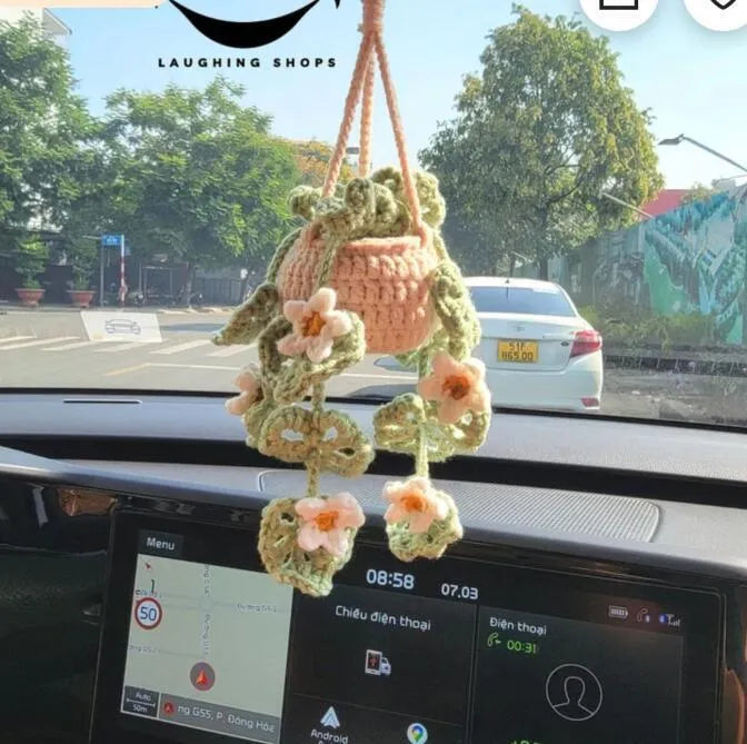 Green and white knitted wool car plant decoration with plastic base and hanging rope