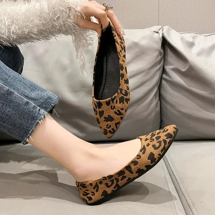 Women's leopard print flat pointed toe pumps with low heel on beige background