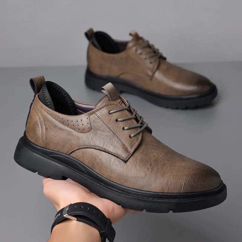 Men's black and brown breathable leather casual shoes with rubber sole and sewing line detail.