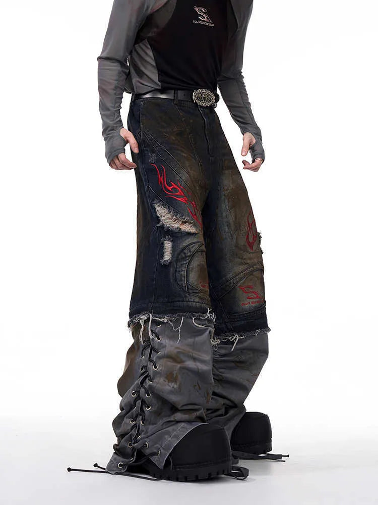 Man modelling retro blue denim jeans with detachable legs and a wide, loose leg fit.