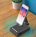 Black mobile phone stand with integrated Bluetooth speaker and microphone on a desk