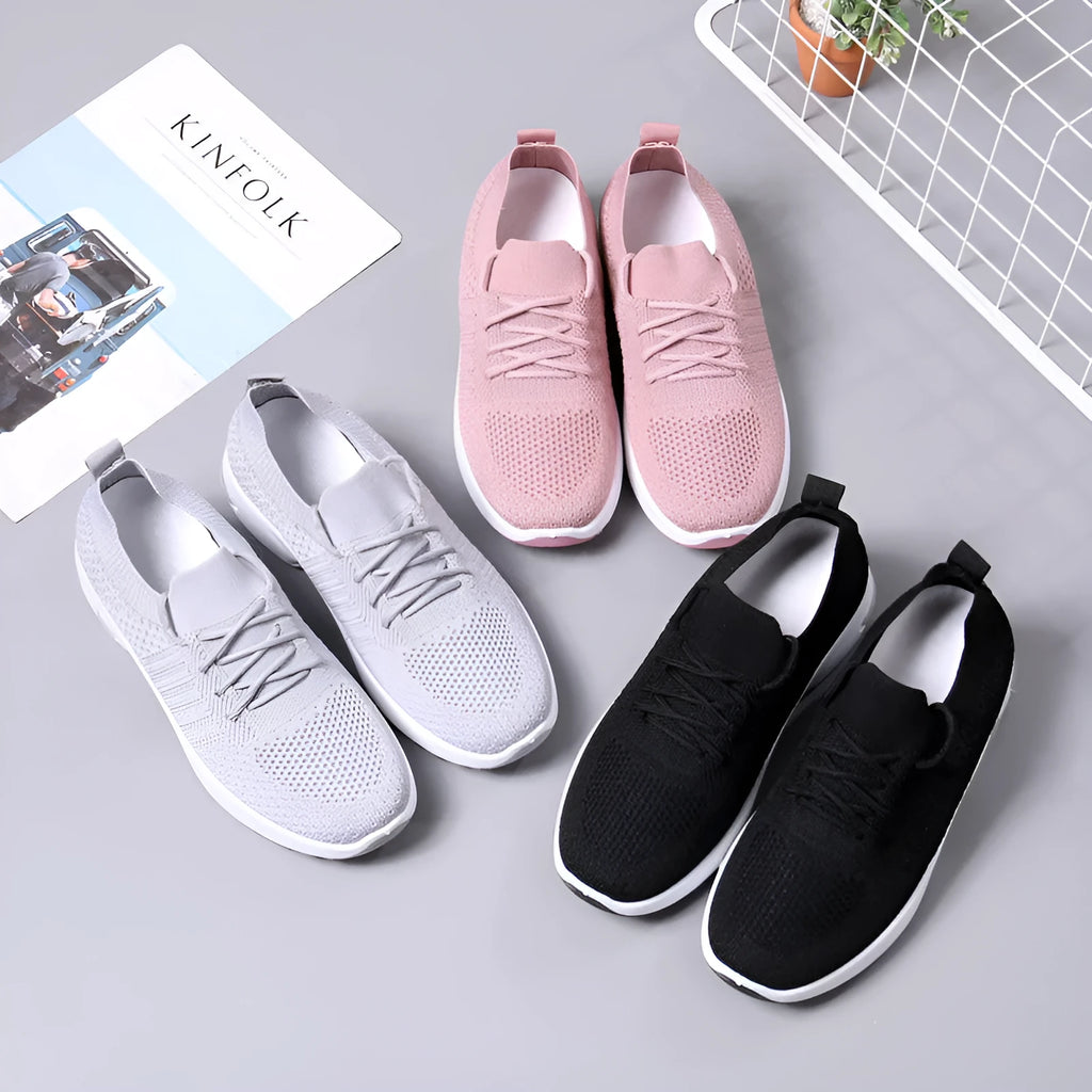 Women's black mesh casual sneaker with a round toe and white non-slip PVC sole on a light background.