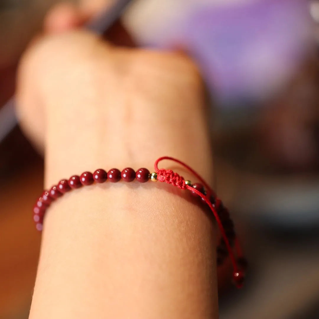 Close-up of a purple gold sand design cinnabar bracelet with geometric Chinese patterns.