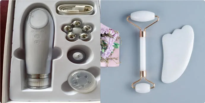 White jade facial roller and gua sha scraper board set on a plain surface.