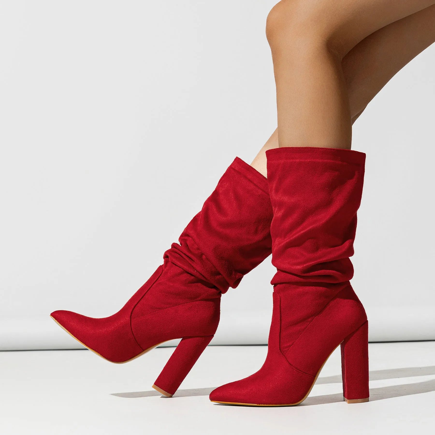 Women's black suede chunky heel pointed toe pull-on boots with mid-calf shaft.