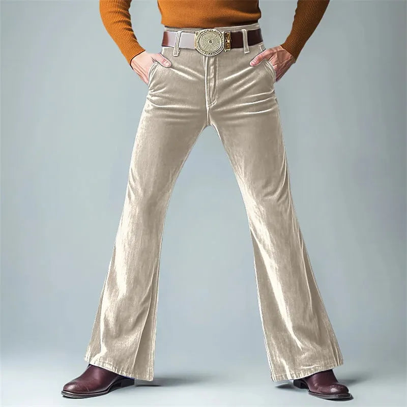 Man wearing slim flared velvet suit trousers in a dark colour for a banquet setting