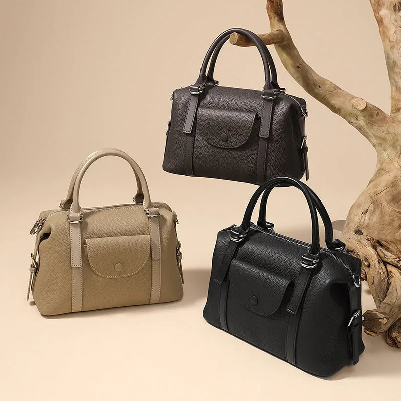 Genuine leather ladies handbag with contrast stitching and lock detail in elephant grey colour