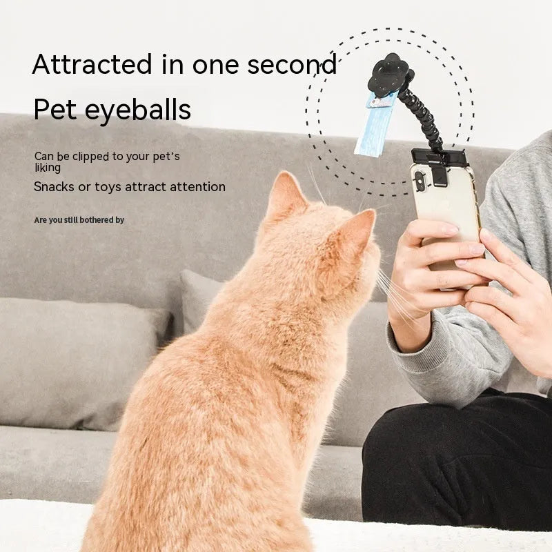 Black pet photography tool with rotating mount and phone clip for holding treats during animal photoshoots