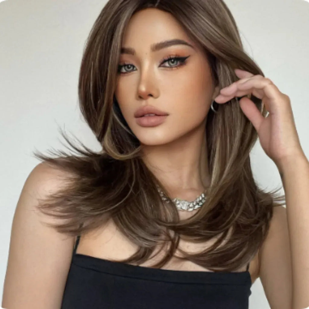 Mid-length platinum gradient curly wig with long bangs on a display stand