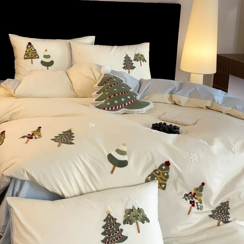Cream Blue cotton duvet cover with embroidered Christmas tree and flower design, part of a four-piece bedding set.