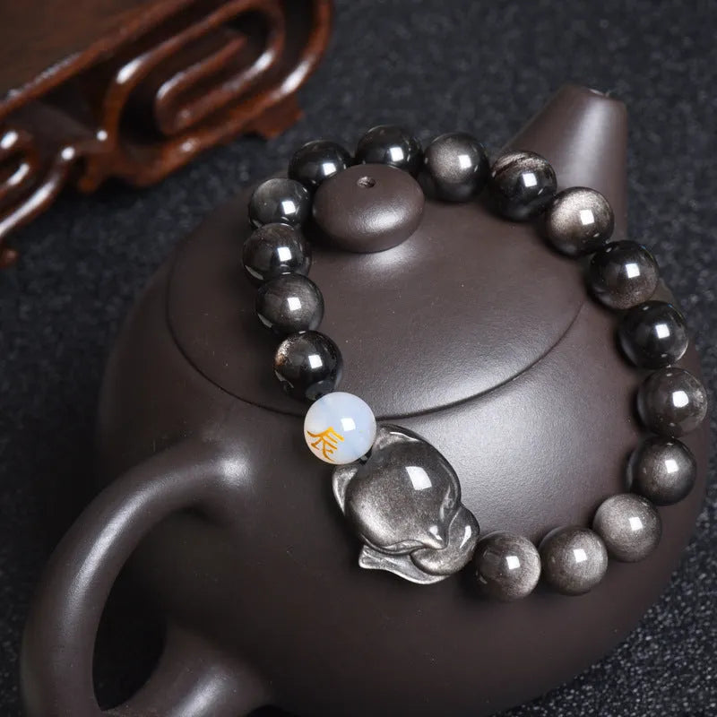Natural obsidian bracelet with 10mm beads in gold, silver, or black finish.
