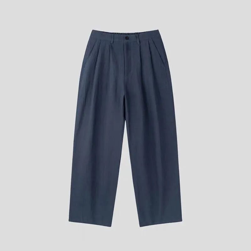 Men's apricot-coloured wide-leg cotton linen trousers with an elastic waistband on a hanger.