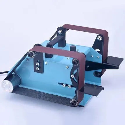 Blue desktop dual-axis belt sander with abrasive belt, variable speed switch, and compact metal frame.
