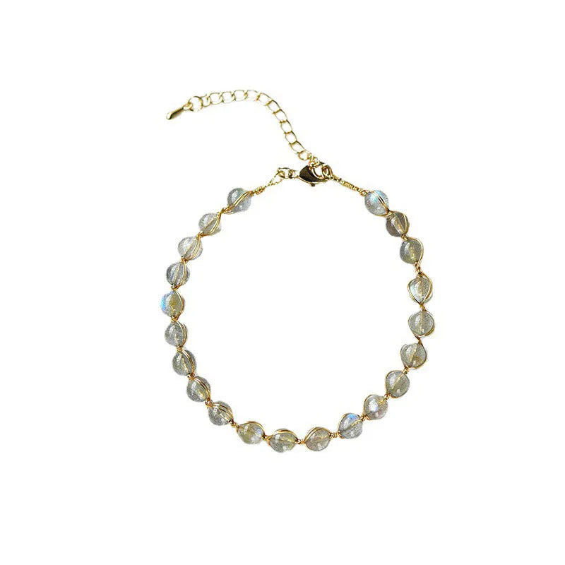 Women's bracelet with blue moonstone beads and gold-gilded metal in a starry sky design.